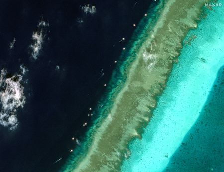 Exclusive-Satellite images reveal floating barrier at mouth of disputed atoll in South China Sea By Reuters